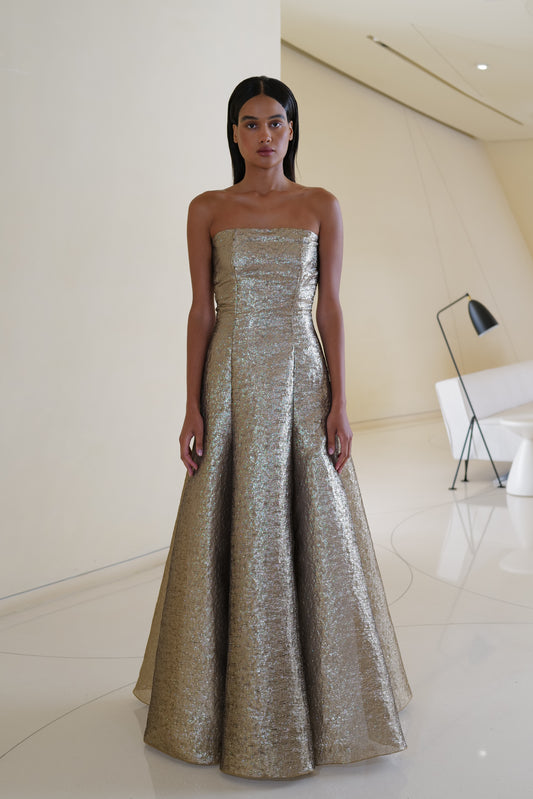 Off shoulder voluminous gown in metallic