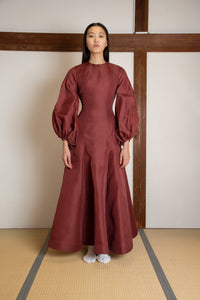 Puffed sleeves voluminous open back gown in silk gazar